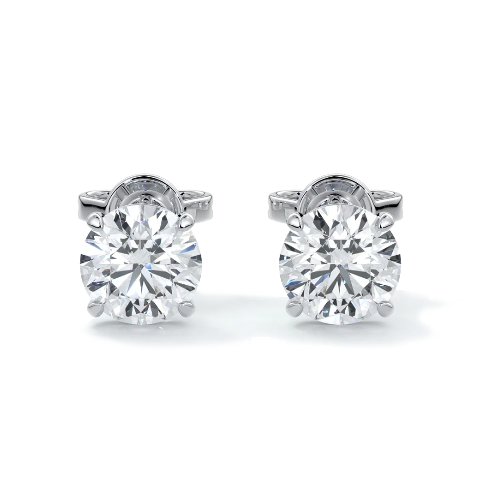 A pair of 14k gold diamond stud earrings with a 4-claw setting