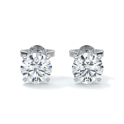 A pair of 14k gold diamond stud earrings with a 4-claw setting