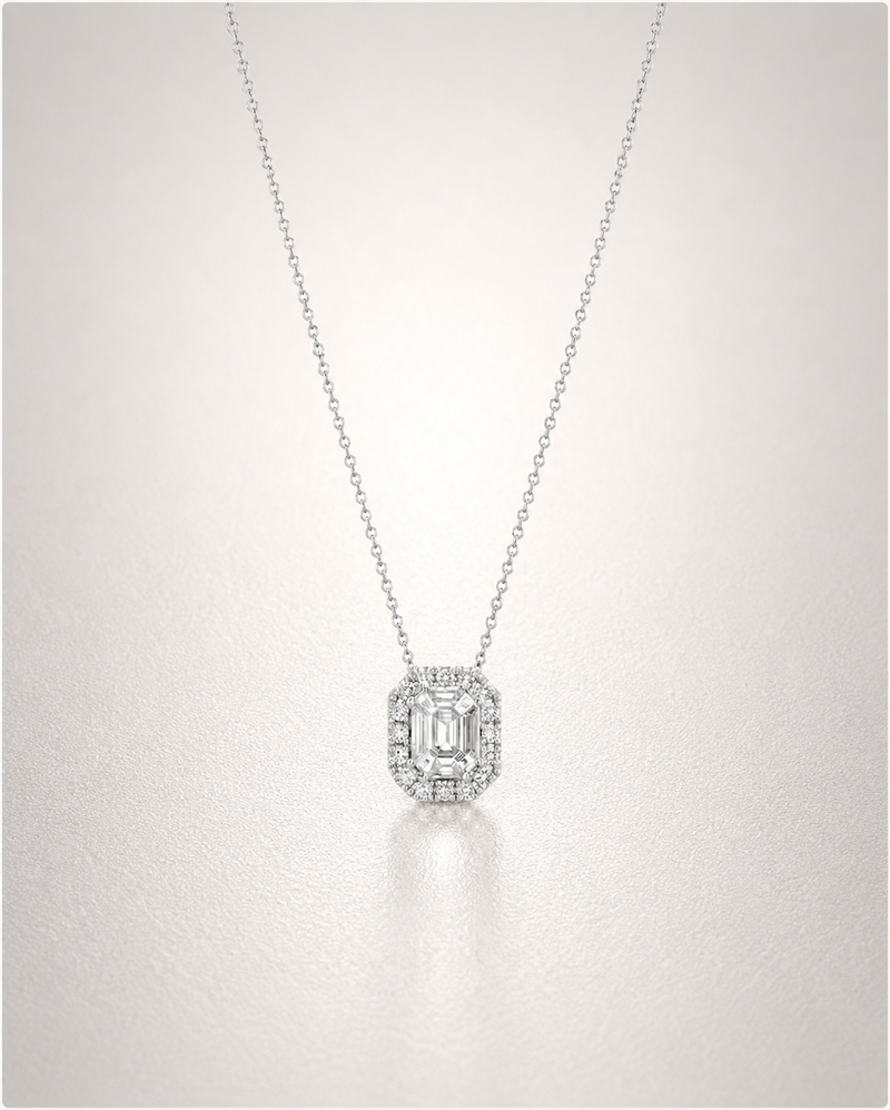 An emerald-cut diamond pendant with a delicate diamond halo on a fine white-gold chain